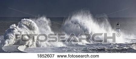 Stock Photo - Seaham, Teesside, England; Waves crashing on lighthouse. Fotosearch