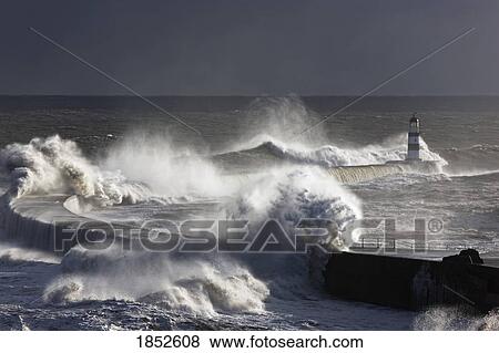 Stock Photo - Seaham, Teesside, England; Waves crashing on lighthouse. Fotosearch