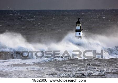 Stock Photograph - Seaham, Teesside, England; Waves crashing on lighthouse. Fotosearch