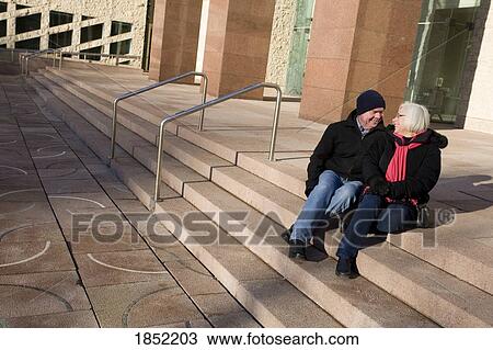 Senior couple; Couple sitting on steps and talking View Large Photo Image Stock Image - Senior couple; Couple sitting on steps and talking. Fotosearch