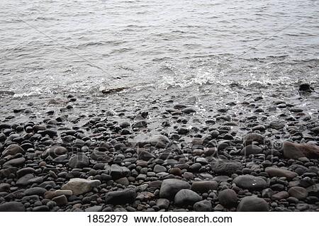 Shoreline; Water splashing against rocks View Large Photo Image Stock Photo - Shoreline; Water splashing against rocks. Fotosearch