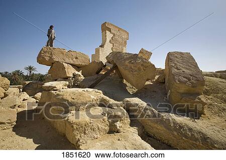 Stock Image - Siwa Oasis, Egypt; A local man stands on the Temple of Umm Ubayd. Fotosearch