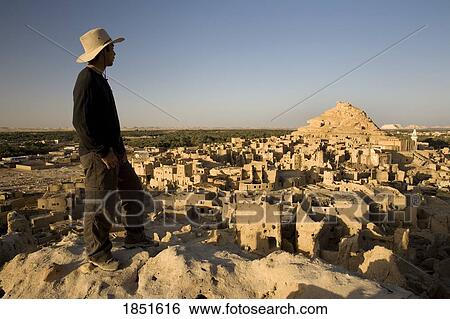 Stock Photograph - Siwa Oasis, Egypt; Man looking out at the fortress of Shali. Fotosearch