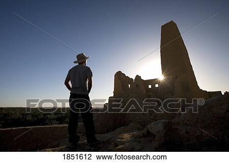Siwa Oasis, Egypt; Man wearing a hat at the Temple of the Oracle of Amun View Large Photo Image Stock Image - Siwa Oasis, Egypt; Man wearing a hat at the Temple of the Oracle of Amun. Fotosearch