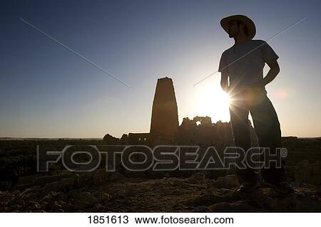 Stock Image - Siwa Oasis, Egypt; Man wearing a hat at the Temple of the Oracle of Amun. Fotosearch
