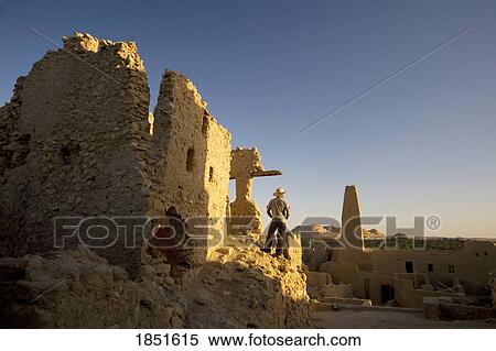 Stock Photography - Siwa Oasis, Egypt; Man wearing a hat at the Temple of the Oracle of Amun. Fotosearch