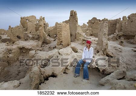 Stock Image - Siwa Town, Siwa Oasis, Egypt, Africa; Tourist enjoys mud brick fortress of Shali. Fotosearch
