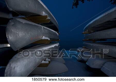 Stock Photo - Snow covered canoes. Fotosearch