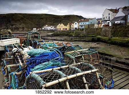 Staithes, Yorkshire, England; Fishing supplies on a dock View Large Photo Image Stock Image - Staithes, Yorkshire, England; Fishing supplies on a dock. Fotosearch