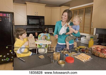 Stock Photo - Stay at home mom with her kids. Fotosearch