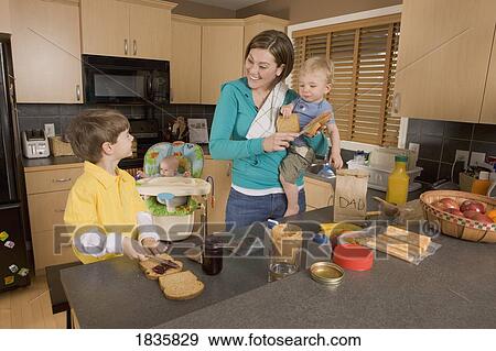 Stay at home mom with her kids View Large Photo Image Stock Photo - Stay at home mom with her kids. Fotosearch
