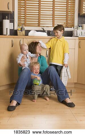 Stock Image - Stay-at-Home mother and her children. Fotosearch