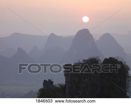 Sun in the haze above the mountains, Guilin, Guangxi, China View Large Photo Image Stock Image - Sun in the haze above the mountains, Guilin, Guangxi, China. Fotosearch