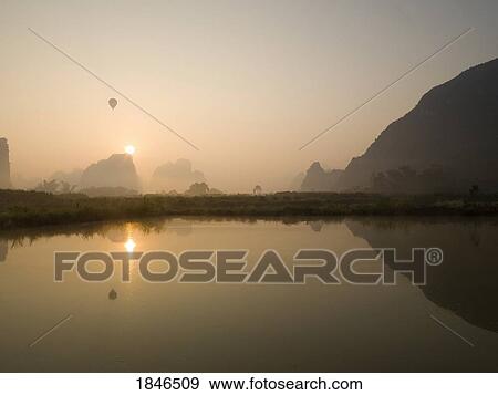 Sun setting over the Yulong river, Guangxi, Zhuang province, China View Large Photo Image Stock Photo - Sun setting over the Yulong river, Guangxi, Zhuang province, China. Fotosearch