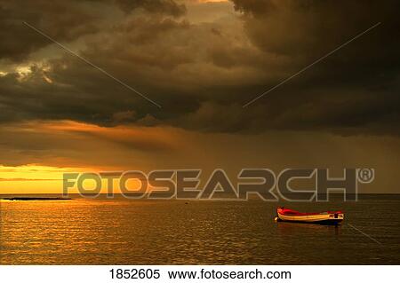 Stock Photography - Sunderland, Tyne and Wear, England; Boat anchored down at sunset. Fotosearch