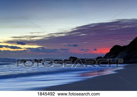Sunset over water and a beach View Large Photo Image Stock Image - Sunset over water and a beach. Fotosearch