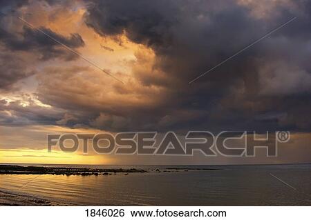 Stock Photograph - Sunset with a stormy sky, Sunderland, Tyne and Wear, England. Fotosearch