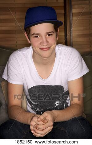 Teenage boy; Portrait of a teenage boy with a hat View Large Photo Image Stock Image - Teenage boy; Portrait of a teenage boy with a hat. Fotosearch