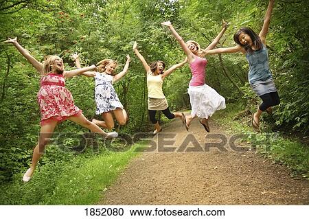 Stock Image - Teenage girls; Teenage girls jumping. Fotosearch