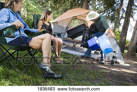 Three people camping View Large Photo Image Stock Image - Three people camping. Fotosearch