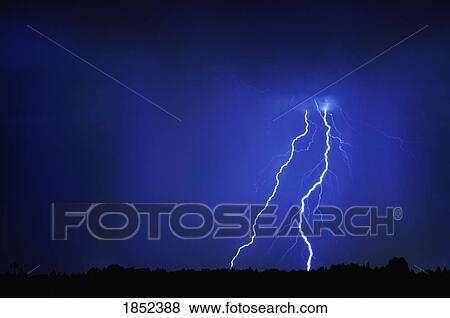 Stock Photo - Thunderstorm; Lightning over prairies. Fotosearch