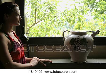 Tuscany, Italy; Woman looking out a window View Large Photo Image Stock Image - Tuscany, Italy; Woman looking out a window. Fotosearch