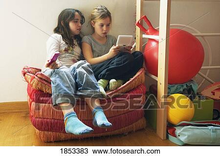 Two girls playing computer game View Large Photo Image Stock Image - Two girls playing computer game. Fotosearch