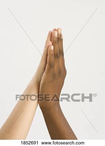 Stock Image - Two hands; Hands in a high five. Fotosearch