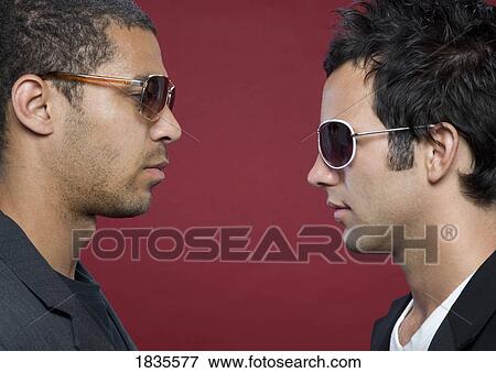 Two men looking at each other View Large Photo Image Stock Photo - Two men looking at each other. Fotosearch