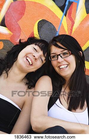 Two women laughing together View Large Photo Image Stock Image - Two women laughing together. Fotosearch