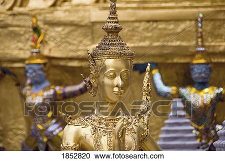 Stock Image - Wat Pra Gaew, Bangkok, Thailand; Golden statue at the King's Palace. Fotosearch