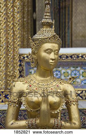 Stock Image - Wat Pra Gaew, Bangkok, Thailand; golden statue in the Kings palace . Fotosearch