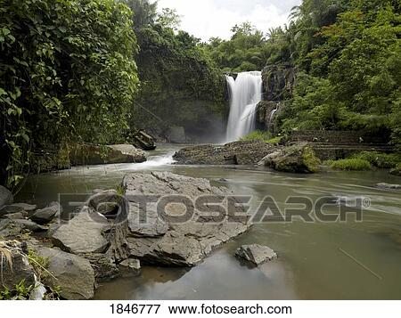 Waterfall flowing into a river, Bali, Indonesia View Large Photo Image Stock Photo - Waterfall flowing into a river, Bali, Indonesia. Fotosearch
