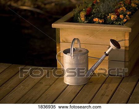 Watering can and flower box View Large Photo Image Stock Photography - Watering can and flower box. Fotosearch