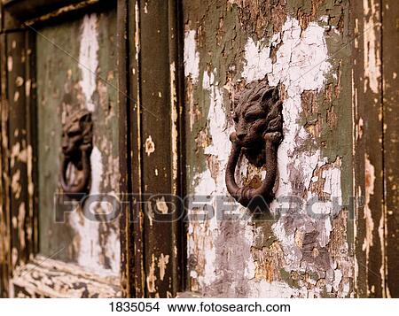 Picture - Weathered doors and door knockers. Fotosearch