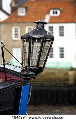 Whitby, Yorkshire, England; Old-fashioned lamp on the front of a boat View Large Photo Image Picture - Whitby, Yorkshire, England; Old-fashioned lamp on the front of a boat. Fotosearch