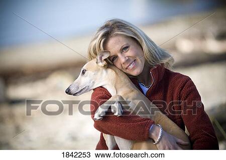 Stock Image - Woman and her dog. Fotosearch