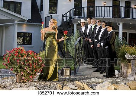 Stock Image - Woman in a formal dress; Woman making a choice in men. Fotosearch