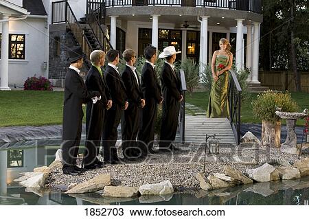 Stock Image - Woman in a formal dress; Woman making a choice in men. Fotosearch