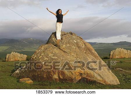 Woman on large boulder in yoga pose View Large Photo Image Stock Photo - Woman on large boulder in yoga pose. Fotosearch