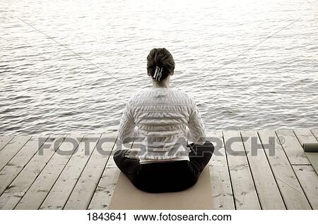 Woman sitting crosslegged on a dock View Large Photo Image Stock Image - Woman sitting crosslegged on a dock. Fotosearch