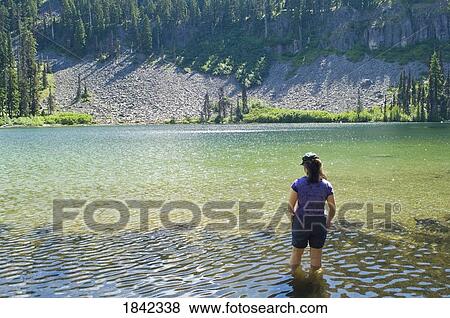 Stock Photo - Woman wading in water, Boulder Lake, Mount Hood National Forest, Oregon, USA. Fotosearch