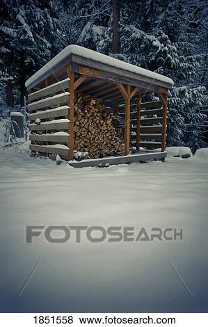 Stock Photo - Wood shack filled with chopped wood. Fotosearch
