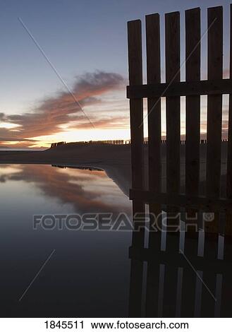 Wooden fence along shoreline of beach View Large Photo Image Stock Image - Wooden fence along shoreline of beach. Fotosearch