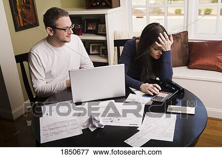 Stock Photo - Young couple with financial stress. Fotosearch