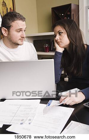 Stock Photo - Young couple with financial stress. Fotosearch