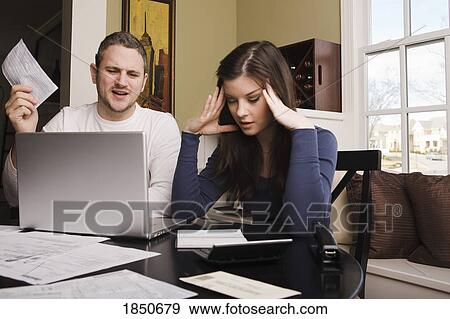 Stock Photo - Young couple with financial stress. Fotosearch