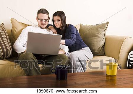Stock Image - Young couple with laptop. Fotosearch