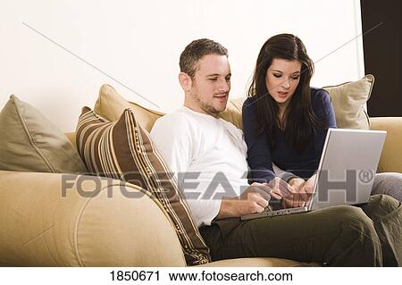 Stock Image - Young couple with laptop. Fotosearch