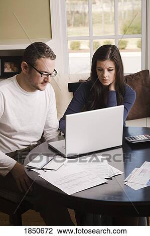 Stock Image - Young couple with laptop. Fotosearch